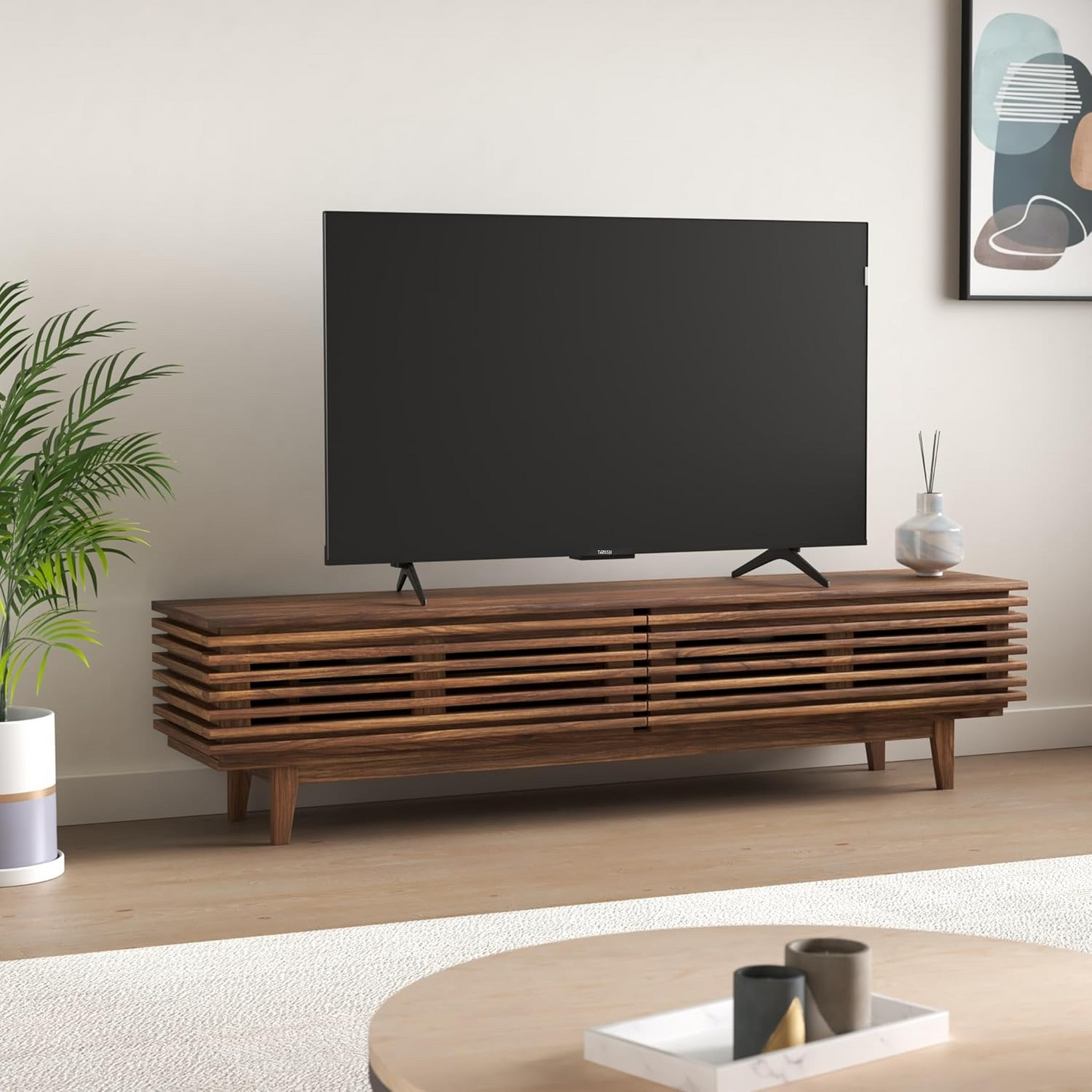 Tanish 55-Inch QLED TV mounted on wall in modern living room setup with edge-to-edge screen