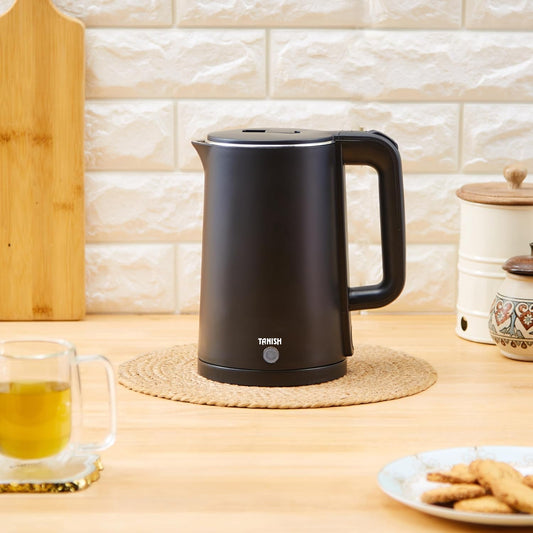 Tanish black electric kettle placed on kitchen counter with tea cup in background